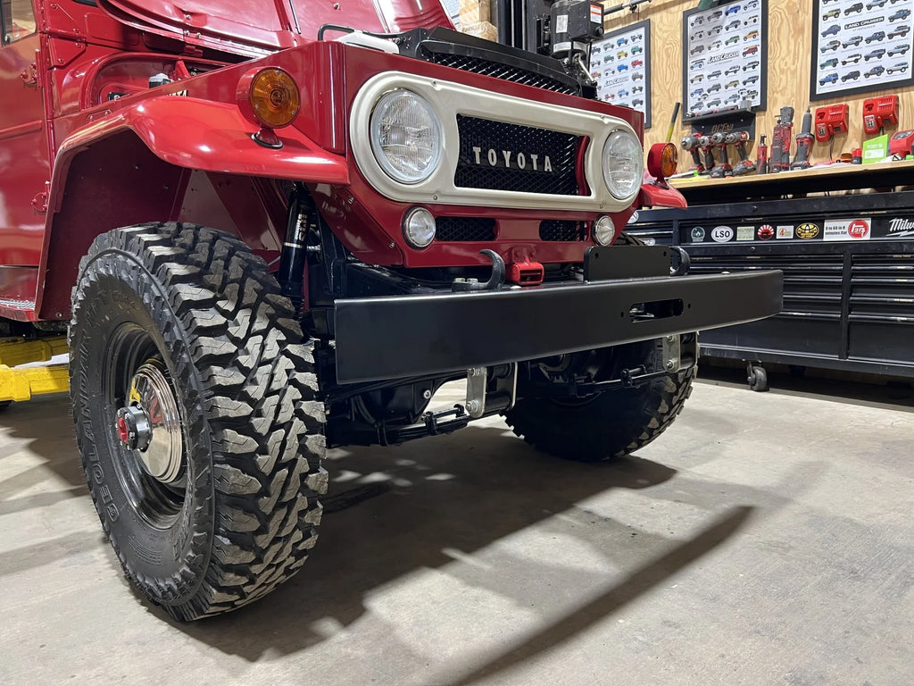 OP Machine and Fabrication classic red Toyota Land Cruiser FJ40 with custom black bumper
