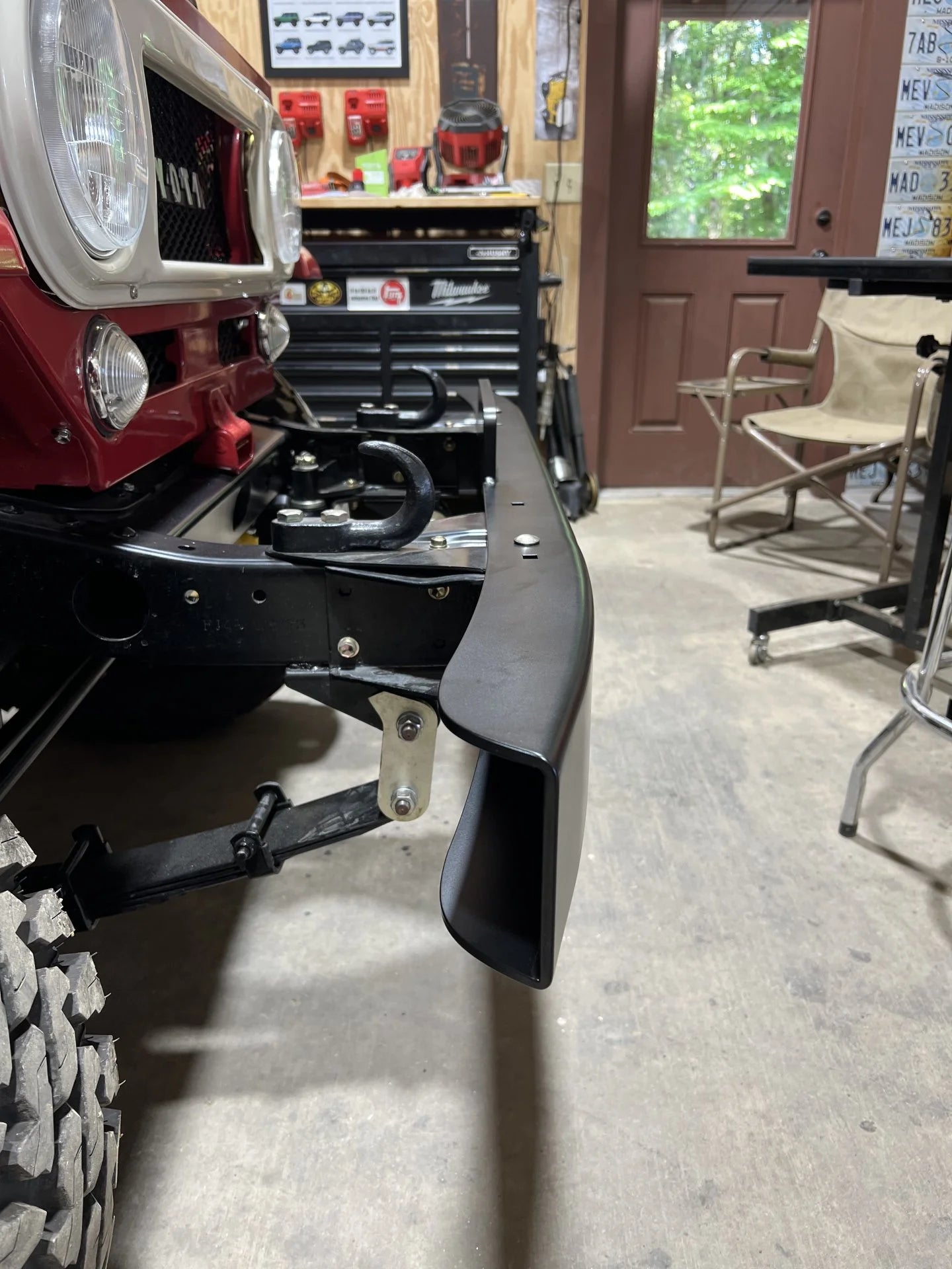 OP Machine and Fabrication classic red Toyota Land Cruiser FJ40 with custom black bumper side view
